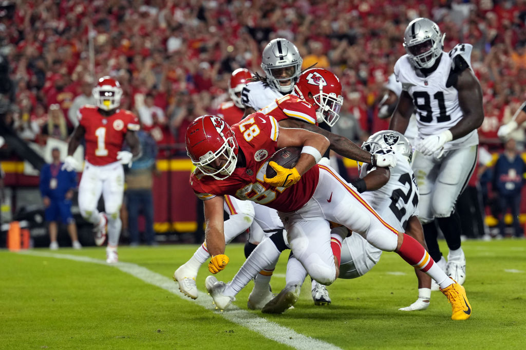 KANSAS CITY, MISSOURI - OCTOBER 10:  Travis Kelce #87 of the Kansas City Chiefs crosses the goal line for a touchdown during the 2nd half of the game against the Las Vegas Raiders at Arrowhead Stadium on October 10, 2022 in Kansas City, Missouri. (Photo by Jason Hanna/Getty Images)