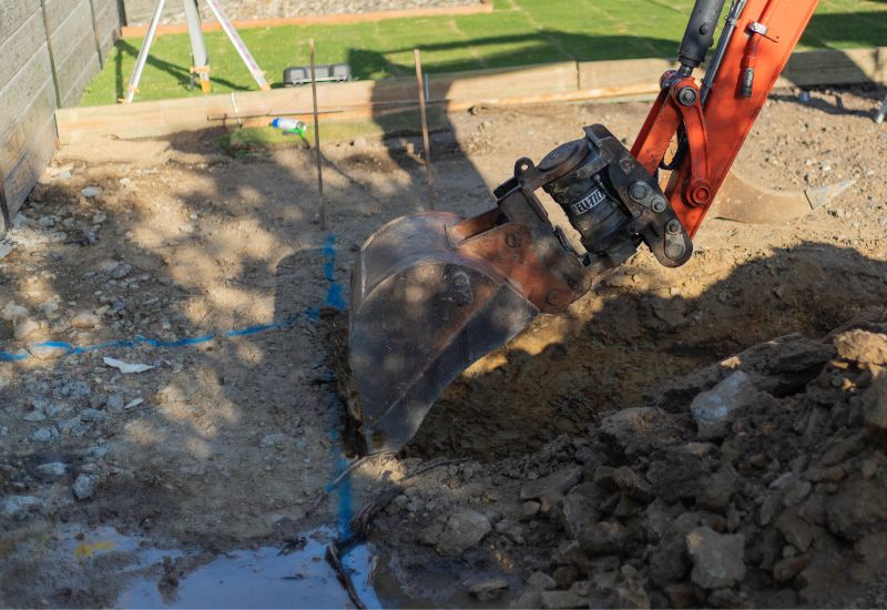 excavator digging out pool hole