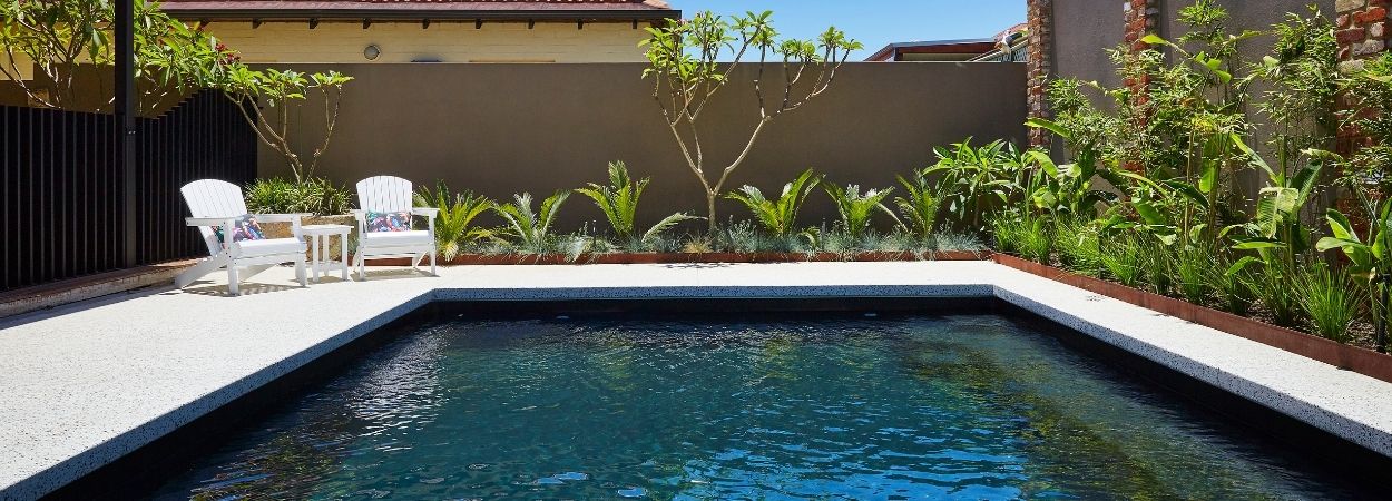 dark coloured pool in backyard