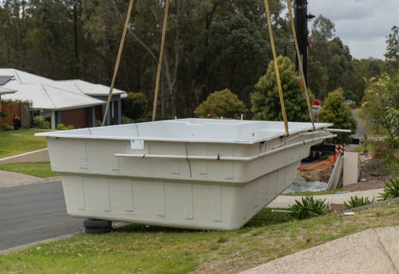 Pool being lifted into air by crane